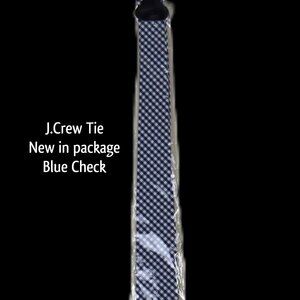 J.CREW tie in a classic blue check. Perfect for any occasion, this tie adds a to